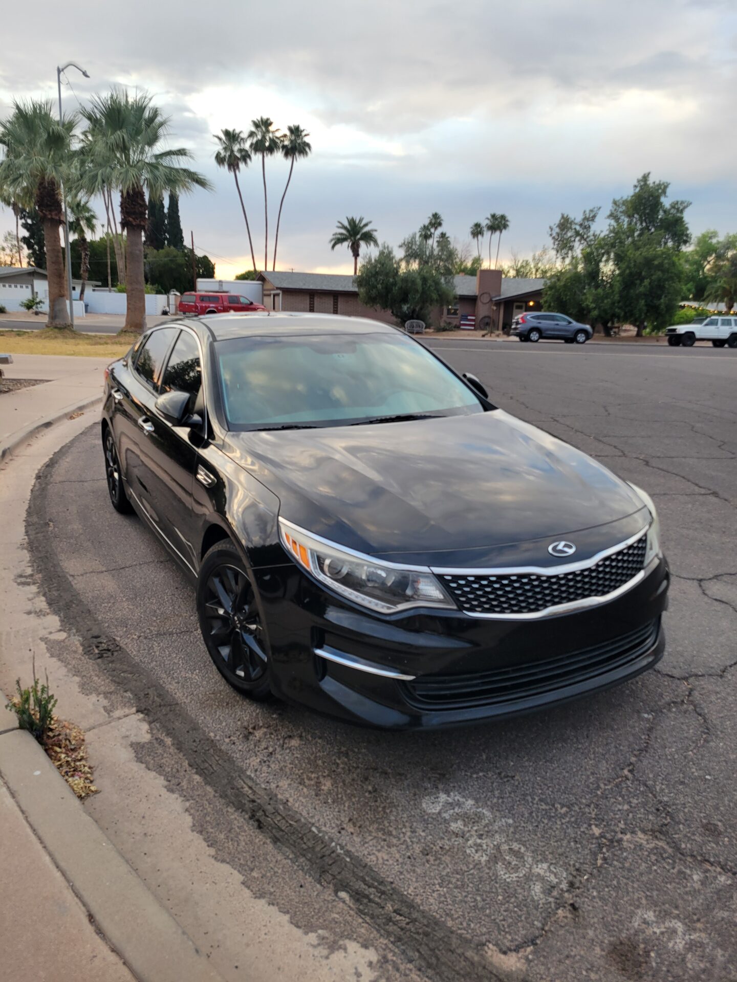 A freshly detailed sedan parked in a Mesa neighborhood at dusk